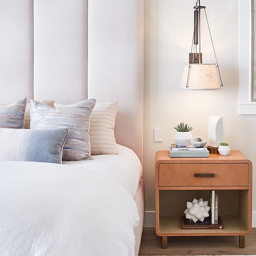 nightstand styled with decor next to bed