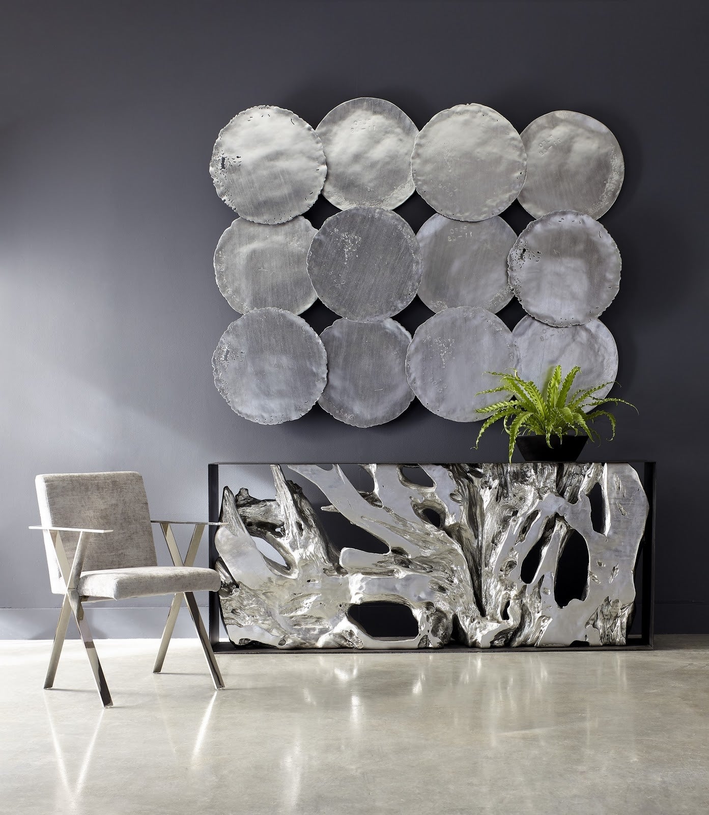 grid installation of silver leaf wall art above console table