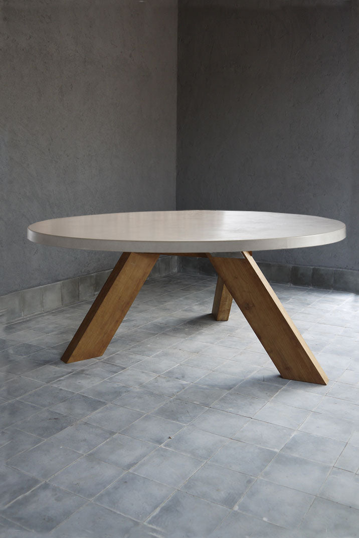 round concrete table with wooden v-shaped base