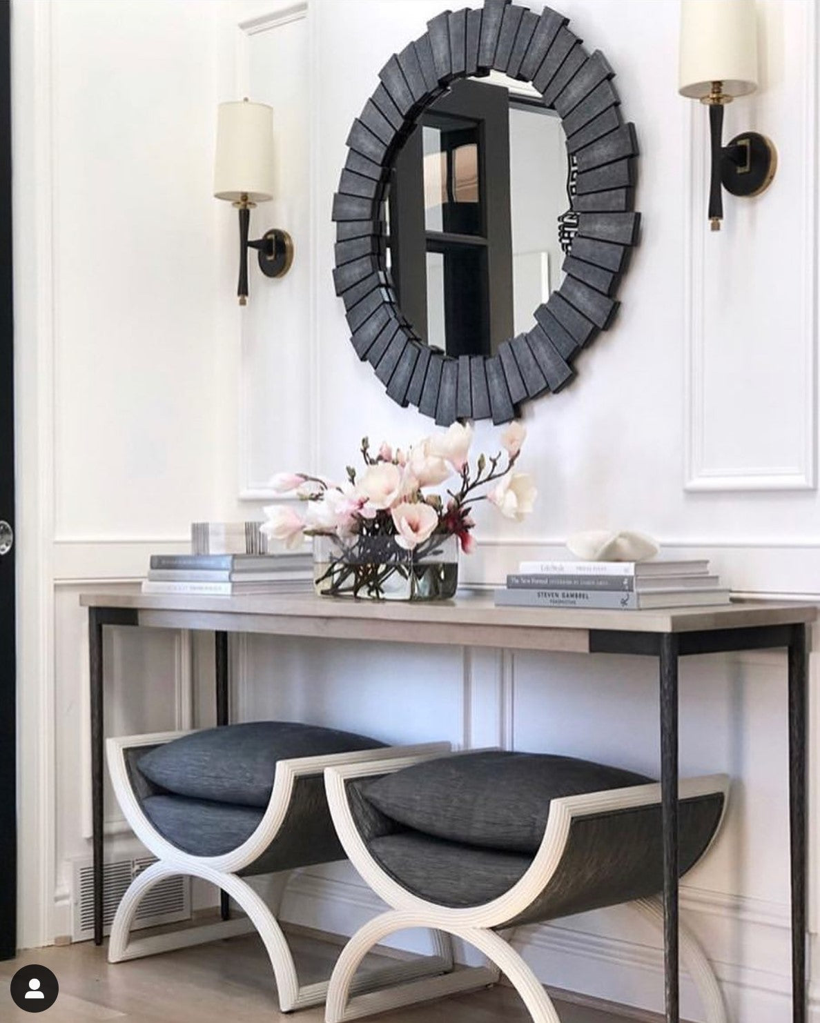 cool grey mirror hanging above console table