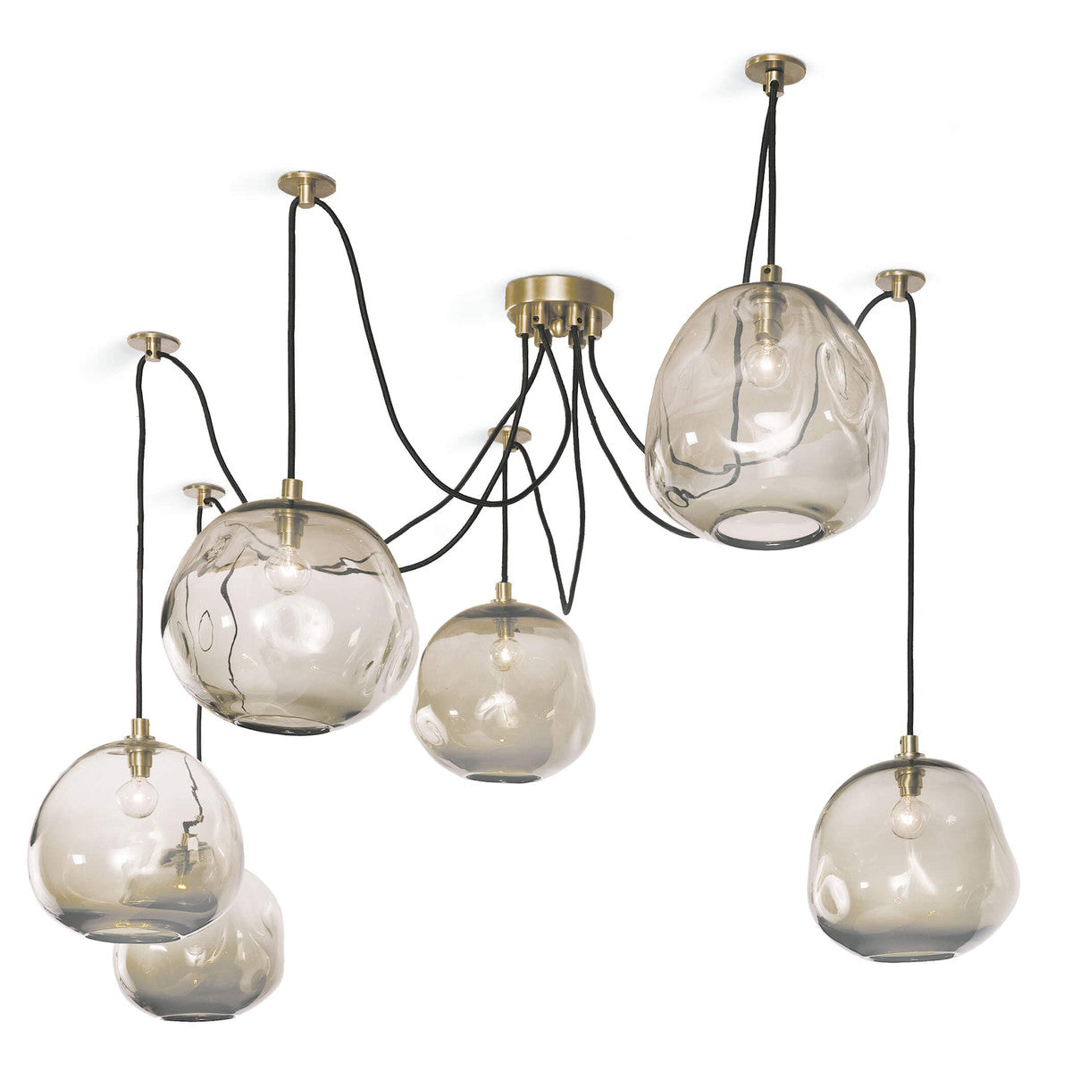 smoke grey glass orbs hanging from black cords on brass ceiling fixtures