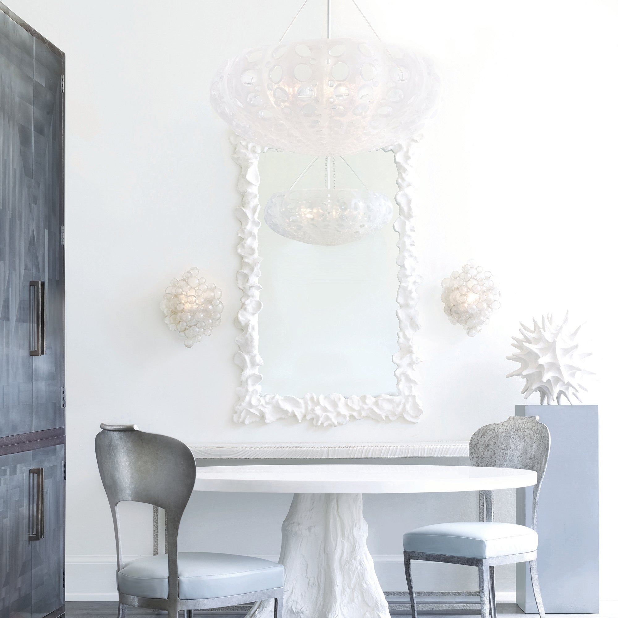 two matching sconces featured on either side of a wall mirror