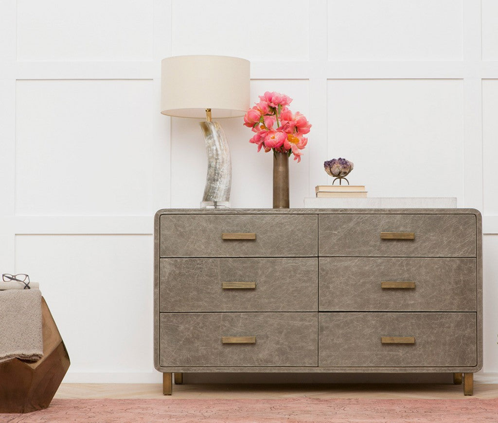 dresser styled with table lamp and decor