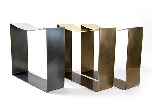 one steel-finished stool shown with two of the same stools finished in darkened brass