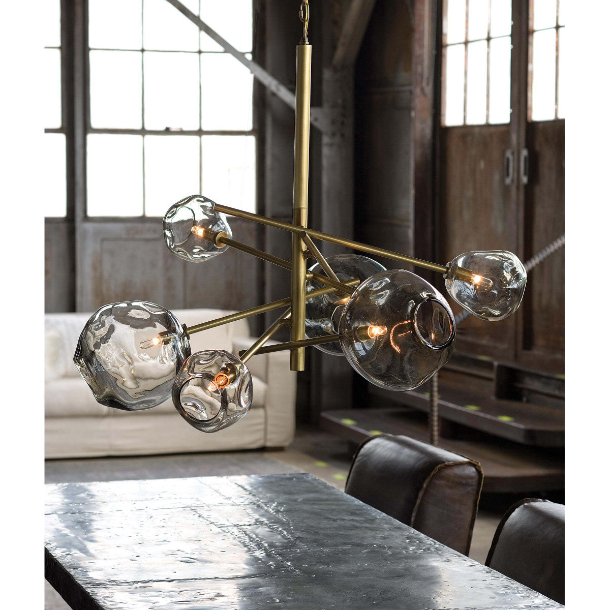 chandelier showcased above dining table in industrial home