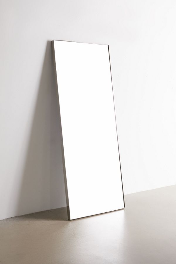rectangular floor mirror leaned against wall with stainless steel frame