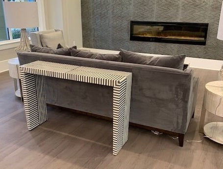 console table styled behind sofa
