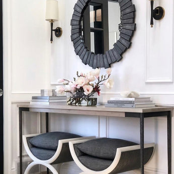 cool grey mirror hanging above console table