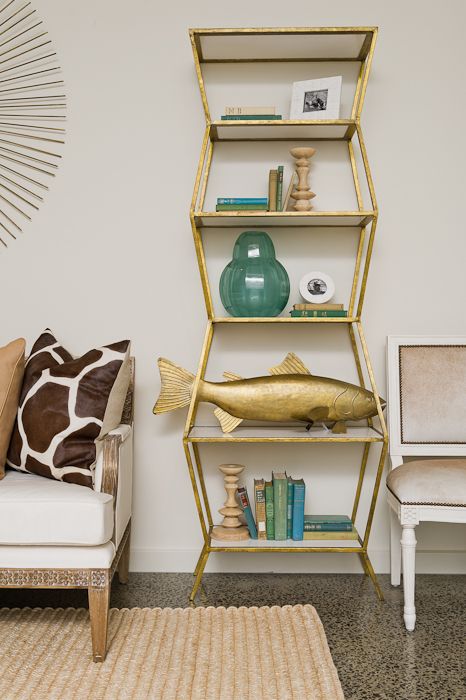 gold shelving unit filled with decor