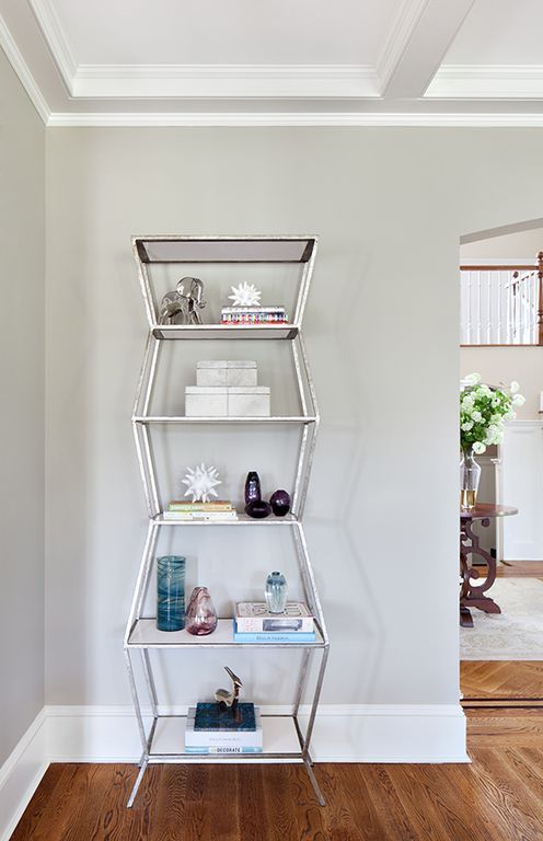 silver shelving unit filled with decor