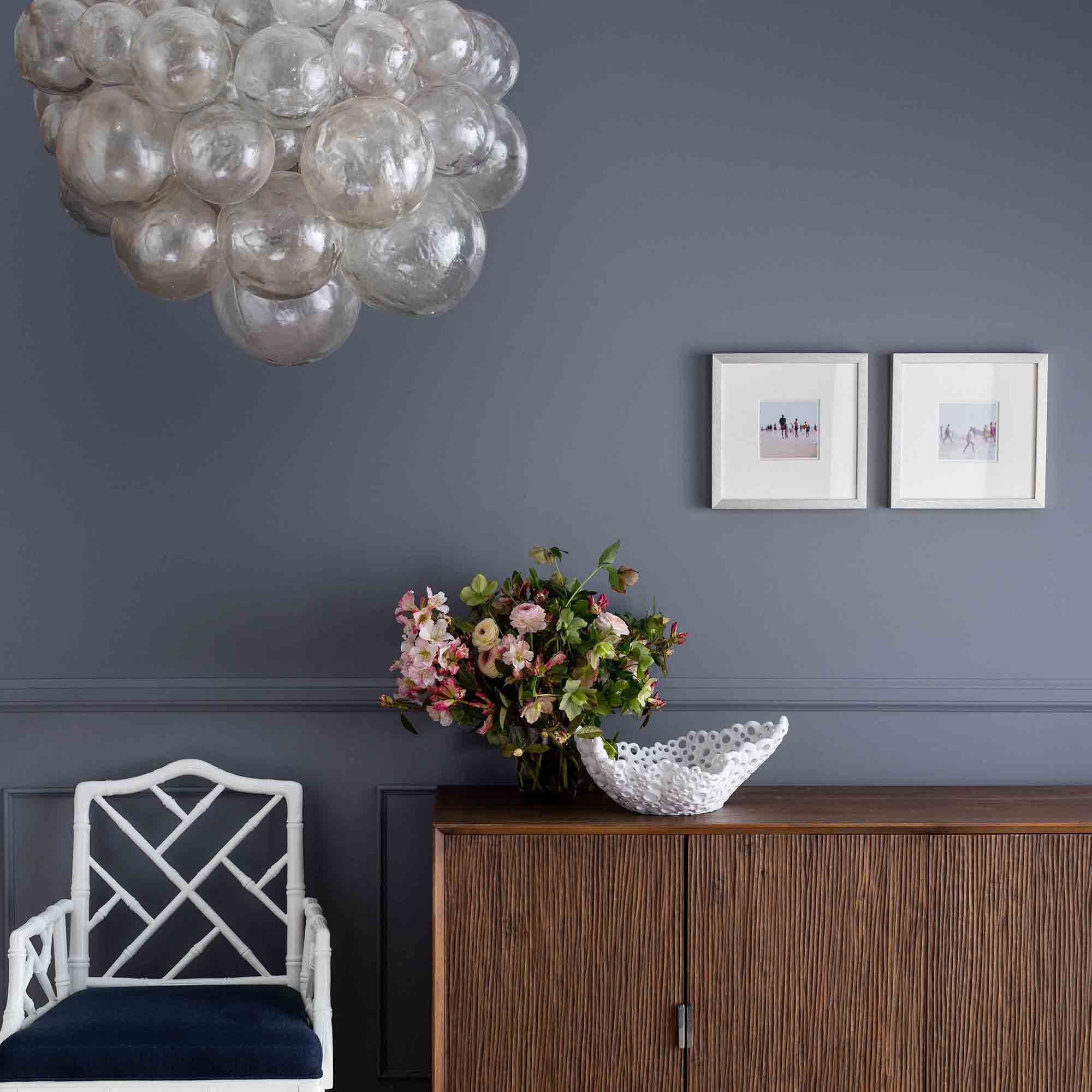 chandelier displayed above accent chair in sitting room