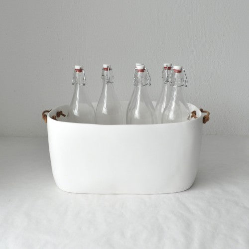 white champagne bucket filled with clear glass bottles