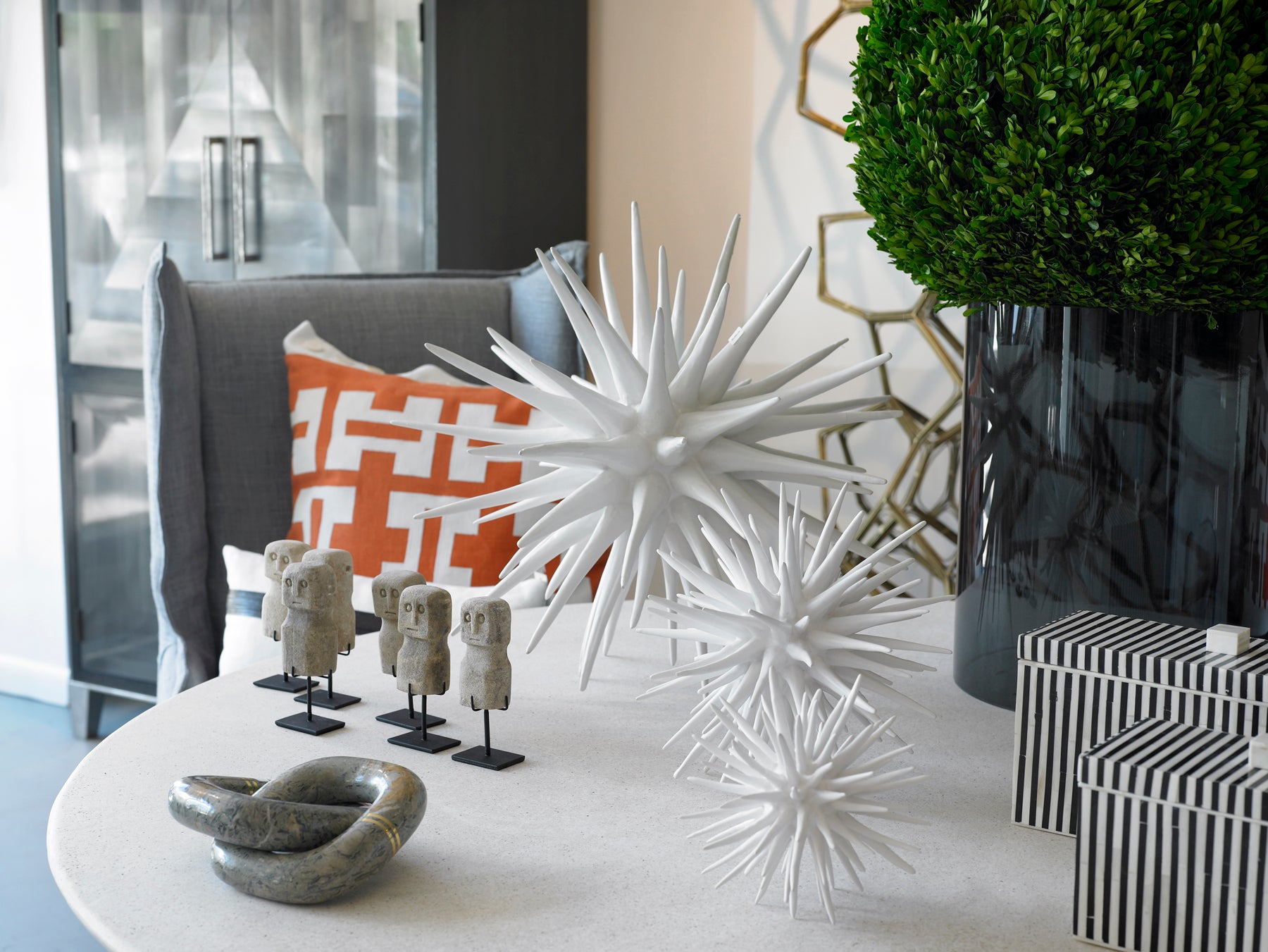 all three sizes of the sea urchin sculpture together on a coffee table
