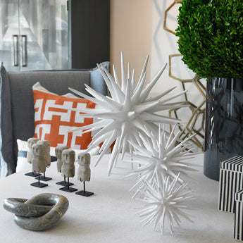 all three sizes of the sea urchin sculpture together on a coffee table
