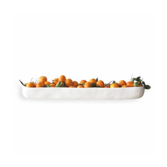 long white trough filled with small citrus fruits