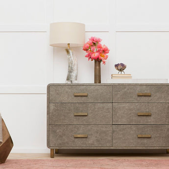 dresser styled with table lamp and decor