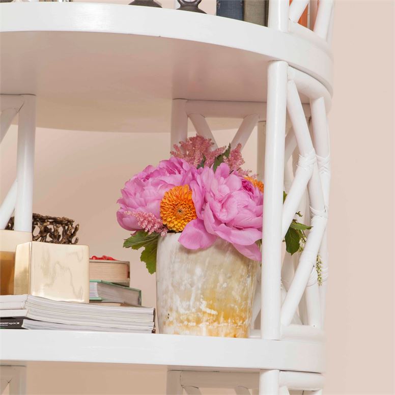 vase with flowers inside featured on shelving unit
