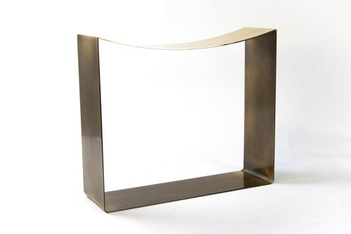 stool finished in darkened brass with concave top side