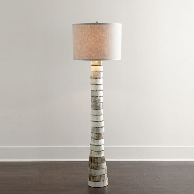 multicolor floor lamp with a base made from stacked discs of natural horn